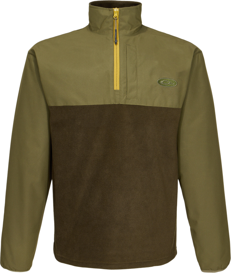 Close-up of the MST Quarter Zip Refuge Eqwader Jacket's zipper and logo, highlighting its innovative waterproof and breathable fabric design for enhanced hunting comfort.