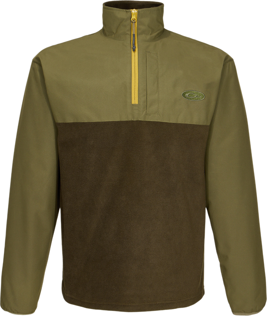 Close-up of the MST Quarter Zip Refuge Eqwader Jacket's zipper and logo, highlighting its innovative waterproof and breathable fabric design for enhanced hunting comfort.