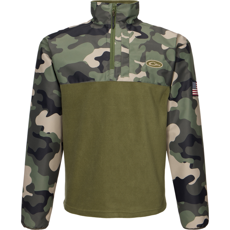 MST Quarter Zip Refuge Eqwader Jacket featuring a close-up of a camouflage pattern, a zipper, and a flag-adorned sleeve, designed for waterfowl hunting comfort and performance.