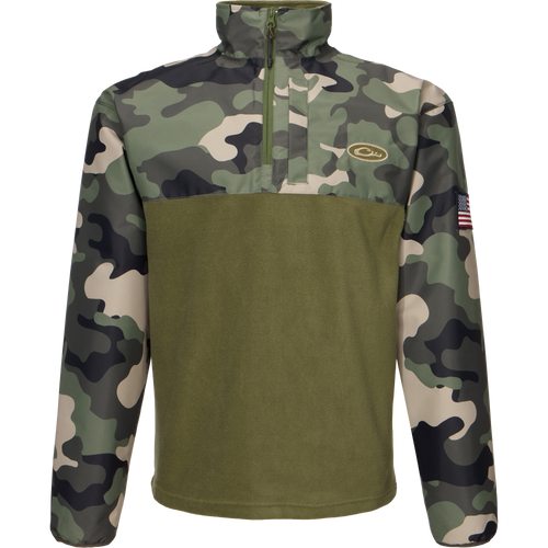 MST Quarter Zip Refuge Eqwader Jacket featuring a close-up of a camouflage pattern, a zipper, and a flag-adorned sleeve, designed for waterfowl hunting comfort and performance.