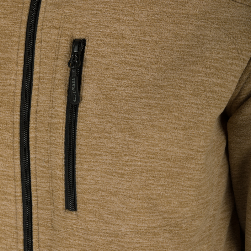 Heathered Windproof Full Zip jacket with close-up of zipper and YKK zippered pockets. Stay warm and stylish in this windproof, microfleece shell jacket.