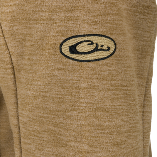 A close-up of the logo on the Heathered Windproof Full Zip jacket by Purewhitelaneshop.