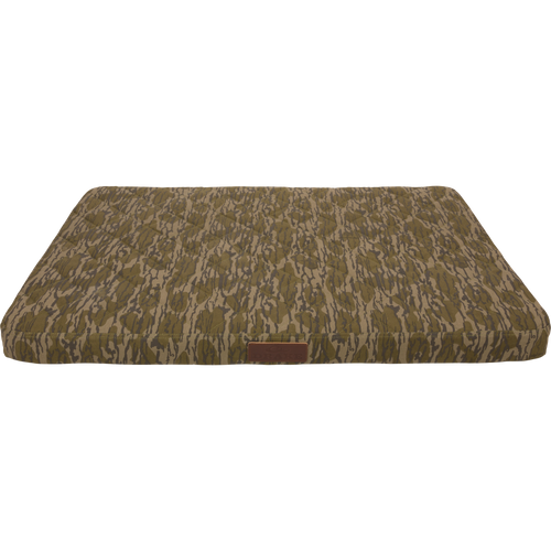 Team Gun Dog Landing Zone Quilted Canvas Dog Bed with camouflage print, tufted top, and leather-style tag, designed for durability and comfort in outdoor settings.