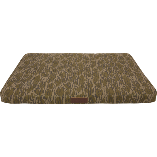Team Gun Dog Landing Zone Quilted Canvas Dog Bed with camouflage print, tufted top, and leather-style tag, designed for durability and comfort in outdoor settings.