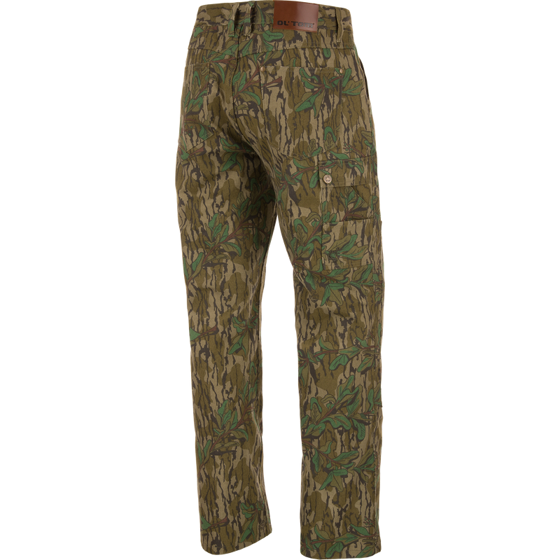 Throwback 80 Field Pant featuring camouflage design, durable cotton twill, reinforced knees, and antique brass riveted pockets, ideal for hunting and outdoor activities.