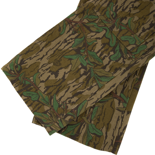 Throwback 80 Field Pant featuring camouflage pattern, durable cotton twill, reinforced knees, and antique brass riveted pockets, ideal for hunting and outdoor activities.