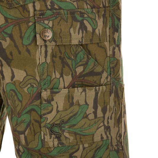 Close-up of the Throwback 80 Field Pant's antique brass riveted pocket and camouflage fabric detail, highlighting durable craftsmanship and functionality for hunting enthusiasts.