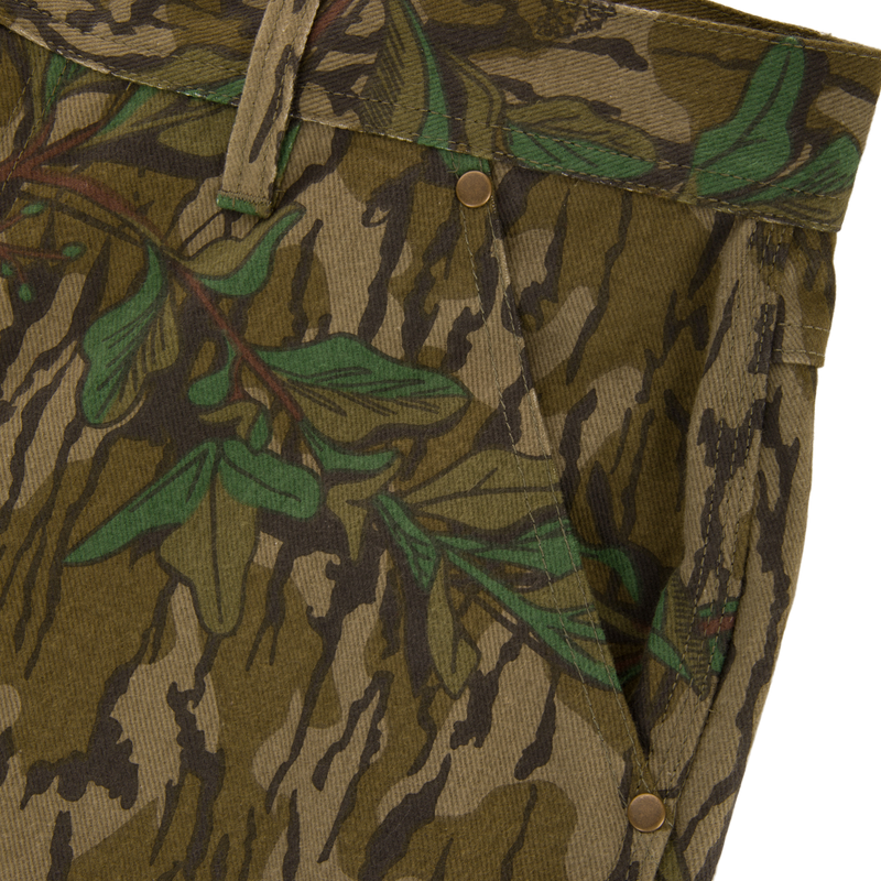 Throwback 80 Field Pant close-up, showcasing durable camouflage fabric, reinforced knees, and brass riveted pockets, ideal for rugged outdoor use.