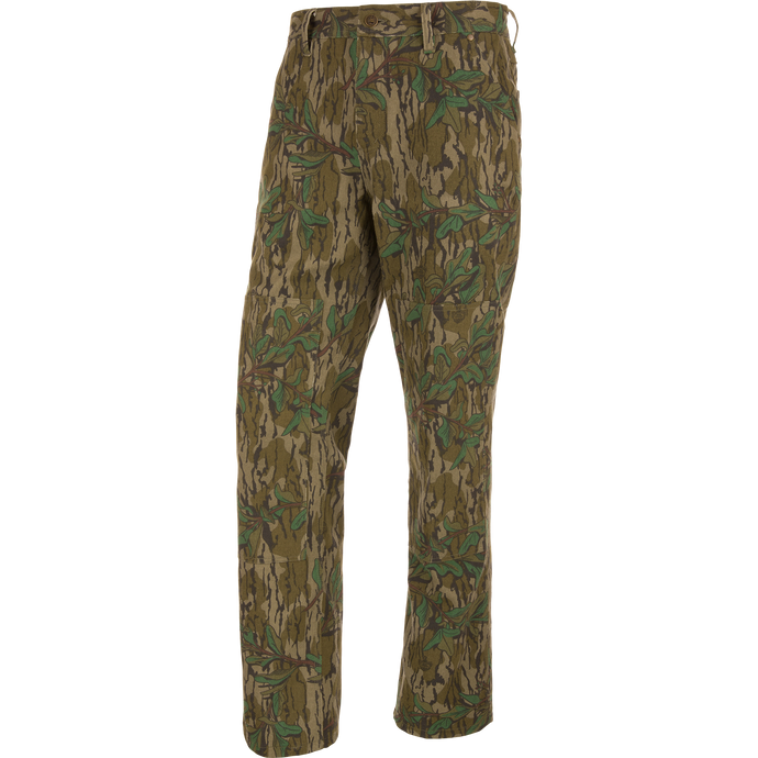 Throwback 80 Field Pant featuring camouflage design, durable cotton twill, reinforced knees, and antique brass riveted pockets, ideal for hunting and outdoor activities.