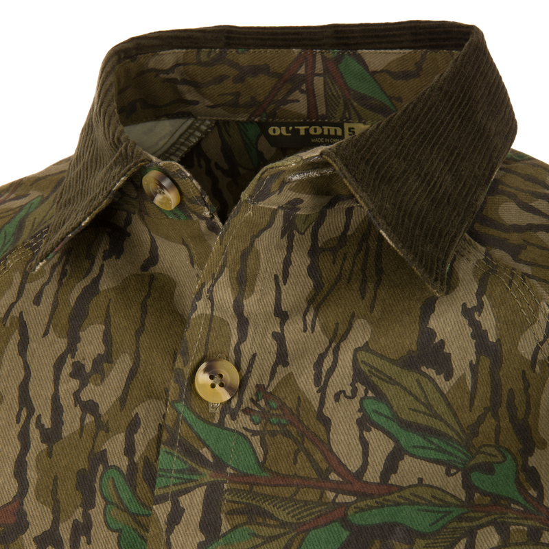 Close-up of the Throwback 80 Field Shirt Jacket featuring a large button, triple-needle stitching, and antique brass riveted pocket for durability and style.
