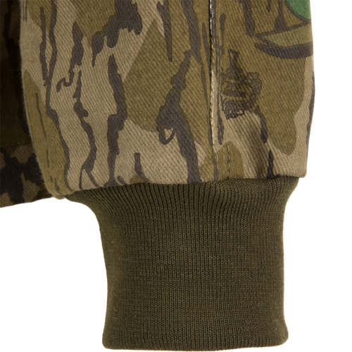 Close-up of the Throwback 80 Field Shirt Jacket showcasing its camouflage pattern, durable stitching, and reinforced elbow design, ideal for rugged outdoor activities.