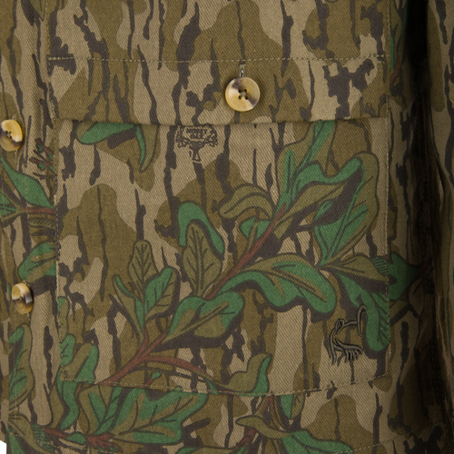 Throwback 80 Field Shirt Jacket close-up showing durable cotton twill fabric, reinforced forearm, large button, and brass riveted pocket details.