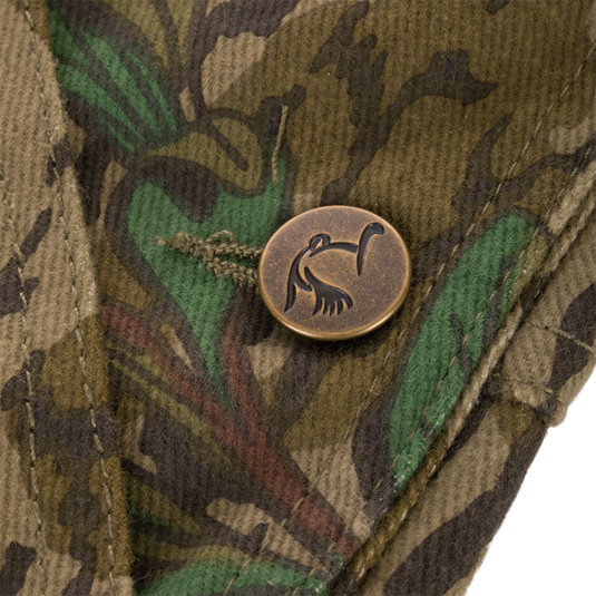Close-up of an antique brass button with a bird design on the Throwback 80 Field Bib, highlighting its vintage-inspired detail and durability.