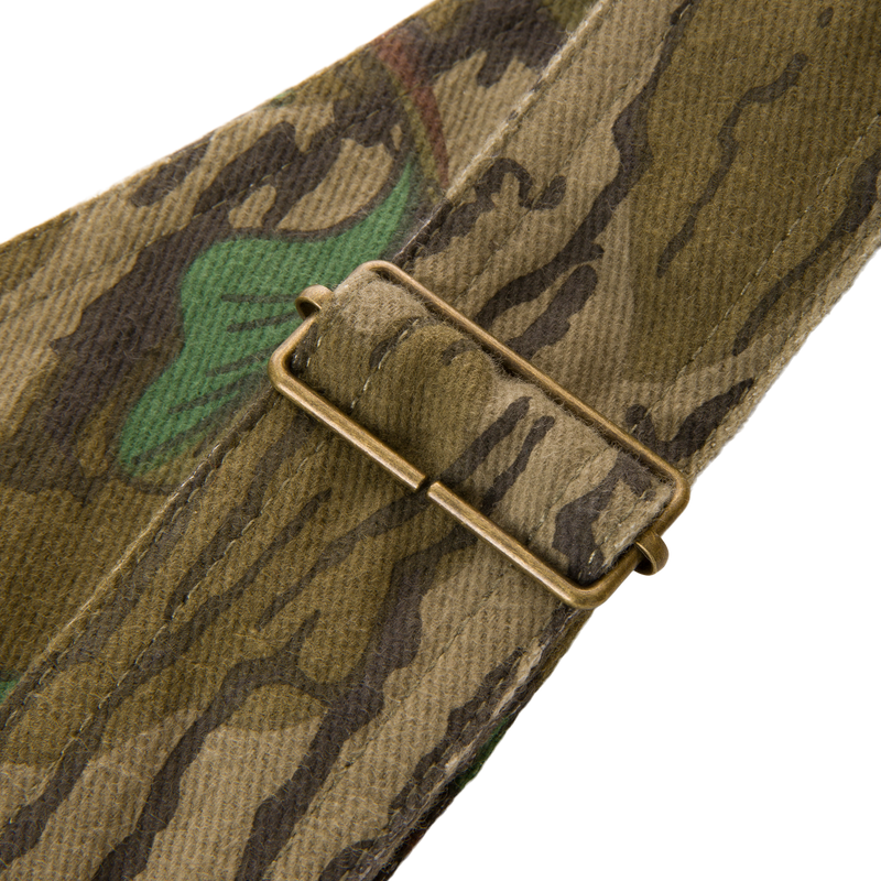Close-up of Throwback 80 Field Bib showing durable cotton twill material and antique brass riveted pockets, designed for tough outdoor tasks.