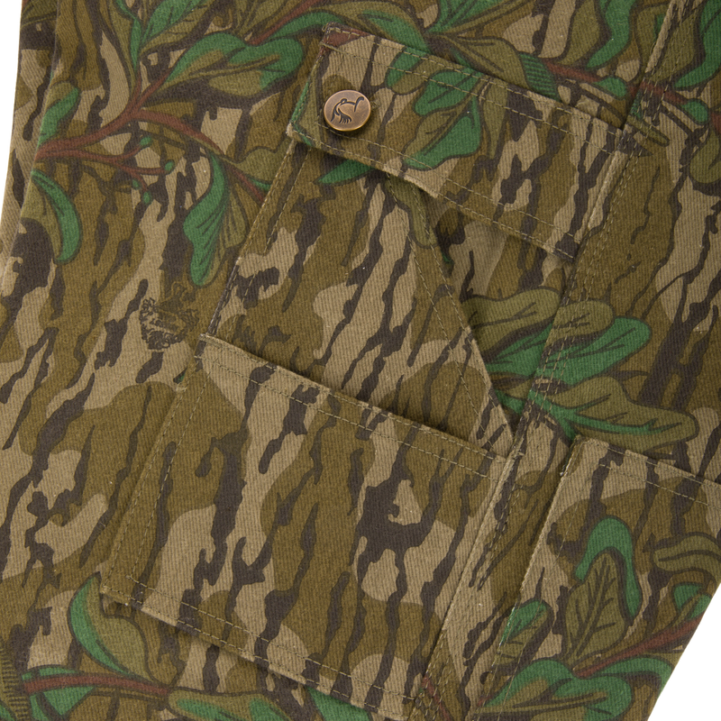 Close-up of the Throwback 80 Field Bib's antique brass button on a pocket, highlighting the durable craftsmanship and vintage style.