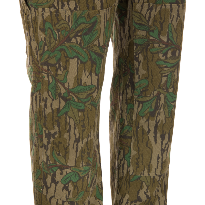 Throwback 80 Field Bib, camouflage pants made from heavy-duty cotton twill, featuring antique brass riveted pockets, triple stitching, and double-layer knee reinforcement.