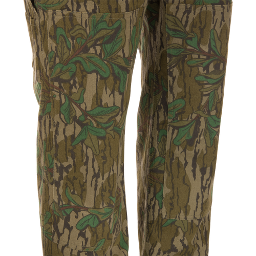 Throwback 80 Field Bib, camouflage pants made from heavy-duty cotton twill, featuring antique brass riveted pockets, triple stitching, and double-layer knee reinforcement.