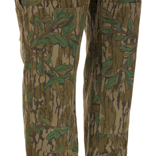 Throwback 80 Field Bib, camouflage pants made from heavy-duty cotton twill, featuring antique brass riveted pockets, triple stitching, and double-layer knee reinforcement.