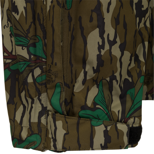 A close-up of the Ultralight Packable Rain Pant, featuring a camouflage pattern fabric. Waterproof, windproof, and breathable, perfect for spring showers during turkey season. Easily packable in a 7" X 3" elastic closure bag. Essential gear from Purewhitelaneshop for hunting and outdoor activities.
