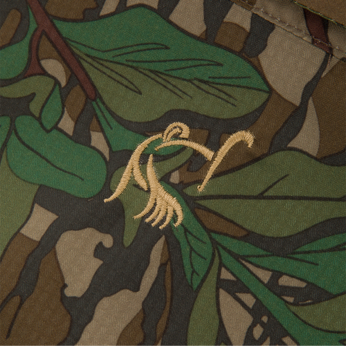 Close-up of the Youth Wingshooter Trey Long Sleeve Shirt's camouflage fabric, showcasing its textured design and moisture-wicking, quick-drying features for hunting and outdoor activities.