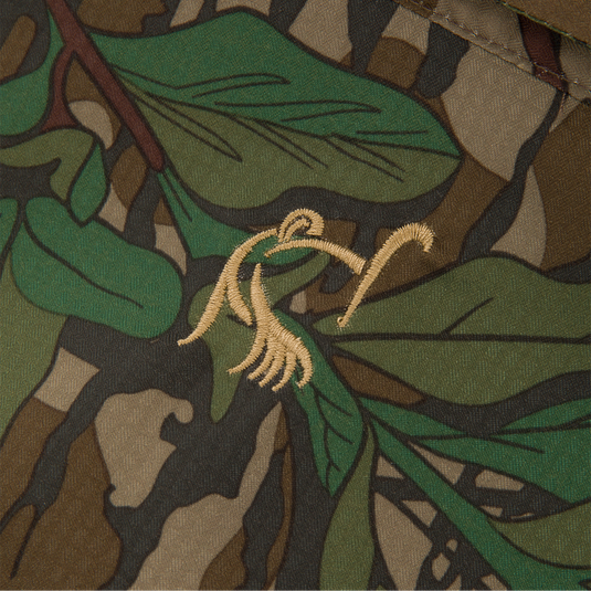 Close-up of the Youth Wingshooter Trey Long Sleeve Shirt's camouflage fabric, showcasing its textured design and moisture-wicking, quick-drying features for hunting and outdoor activities.