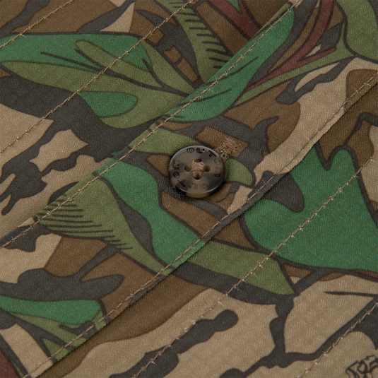 Close-up of a button on the Men's Camo Wingshooter Trey Shirt, showcasing the shirt's premium craftsmanship and technical features for optimal performance in outdoor activities.