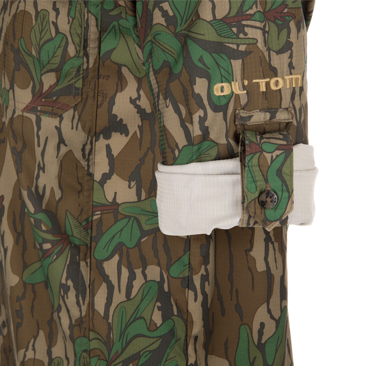 Close-up of Youth Wingshooter Trey Long Sleeve Shirt featuring camouflage pattern, button details, and vented cape back.