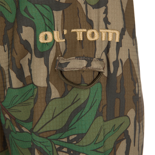 Men's Camo Wingshooter Trey Shirt, featuring a close-up of camouflage fabric and chest pockets, showcasing its lightweight, moisture-wicking, and vented design.