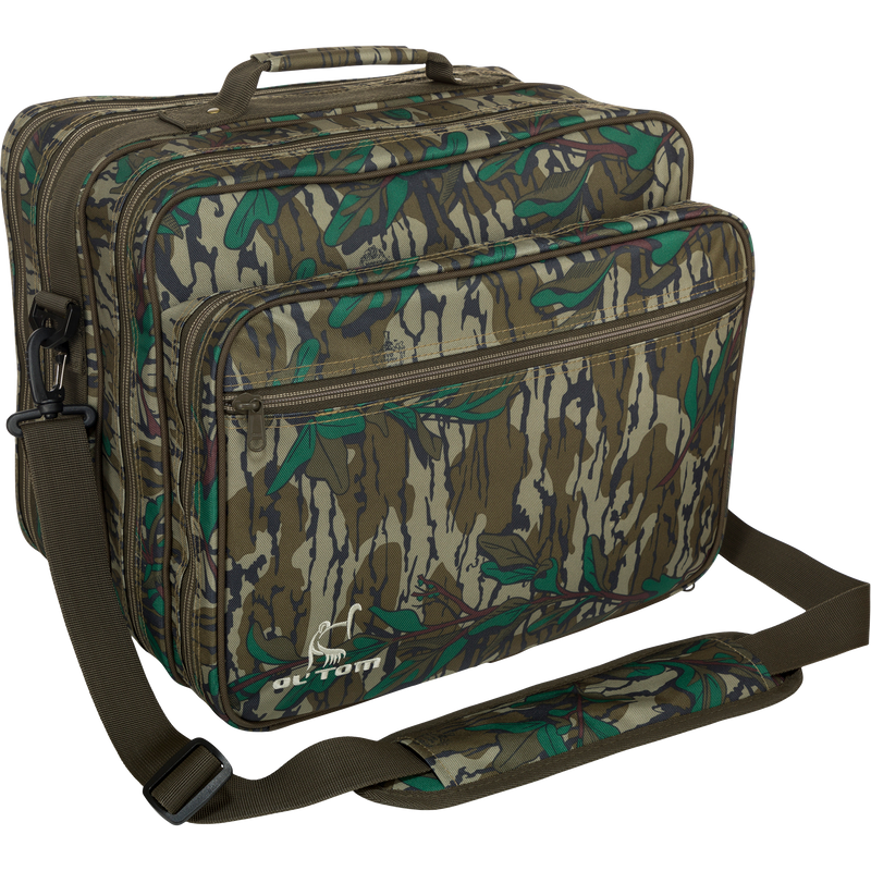 Ol' Tom Treasure Chest, a camouflage hunting bag with a strap, features multiple compartments for organizing turkey season gear and tools.