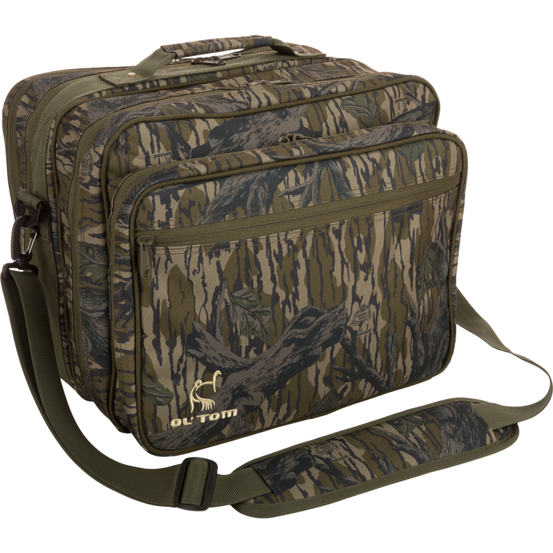 Ol' Tom Treasure Chest camouflage bag with a logo, featuring adjustable strap and multiple compartments for organizing turkey hunting calls and tools.