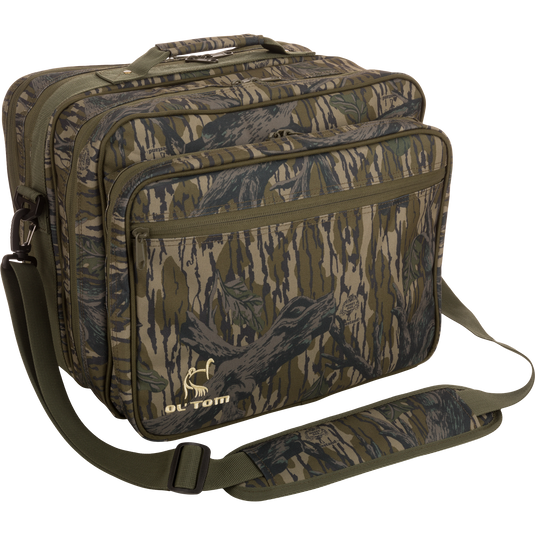 Ol' Tom Treasure Chest camouflage bag with a logo, featuring adjustable strap and multiple compartments for organizing turkey hunting calls and tools.