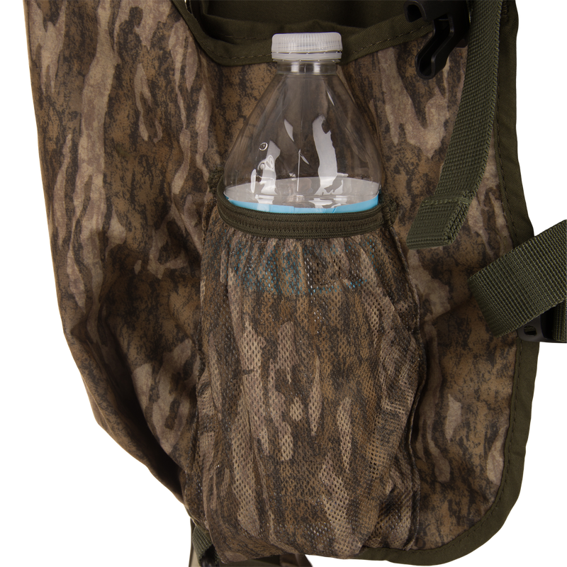 Time & Motion™ Gunslinger Turkey Vest with camouflage bag shown, featuring adjustable straps, mesh pockets for water bottle, and efficient pocket organization for hunting essentials.