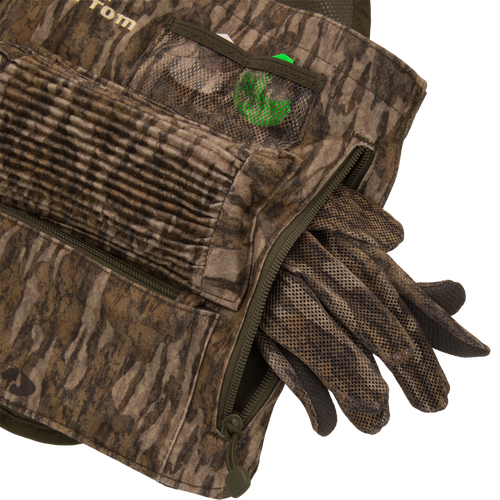 Time & Motion™ Gunslinger Turkey Vest with visible gloves, designed for intuitive gear access, featuring multiple call pockets and a removable seat cushion for hunting convenience.