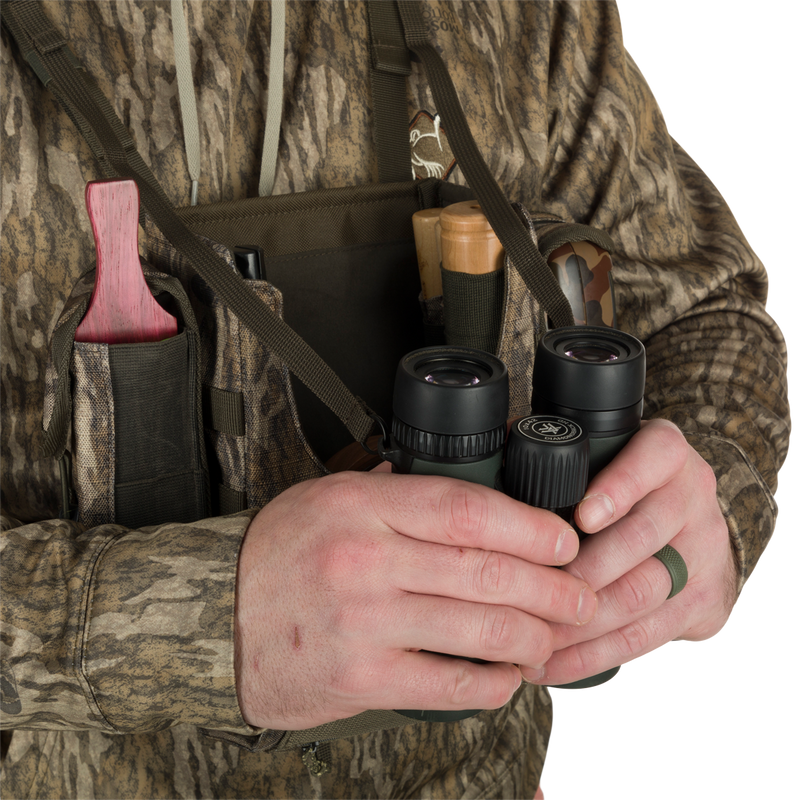 Turkey Chest Pack held by a person, showcasing its bino harness and multiple pockets, ideal for hunting trips with lightweight and durable design.