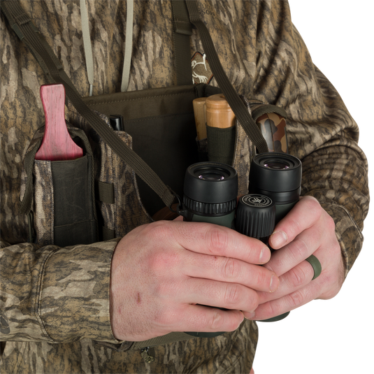 Turkey Chest Pack held by a person, showcasing its bino harness and multiple pockets, ideal for hunting trips with lightweight and durable design.