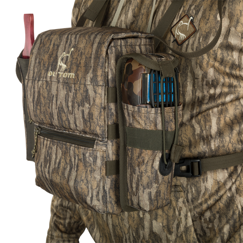 Turkey Chest Pack with camouflage design, featuring a removable bino harness, multiple pockets, and a stowable rain fly, ideal for hunting trips.