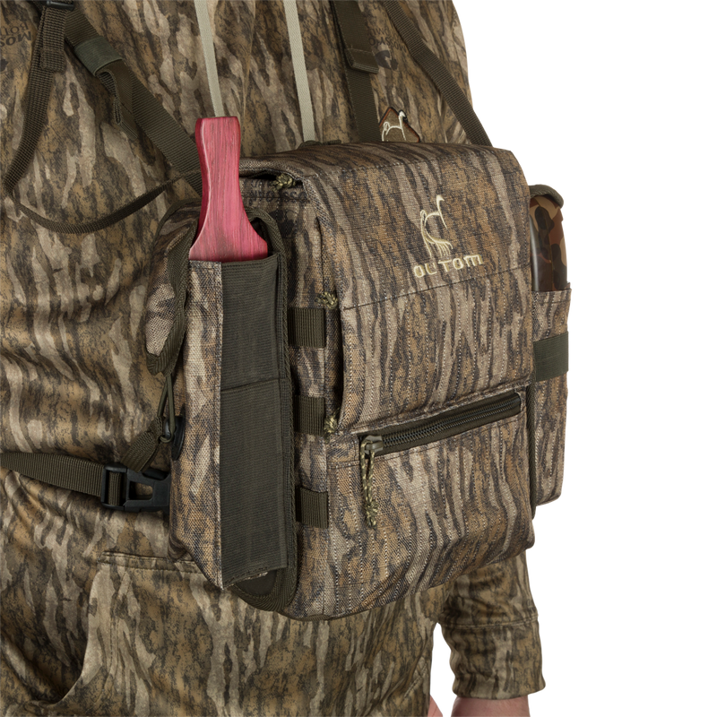Turkey Chest Pack in camouflage, featuring multiple pockets, detachable bino harness, and a stowable rain fly, ideal for hunting trips.