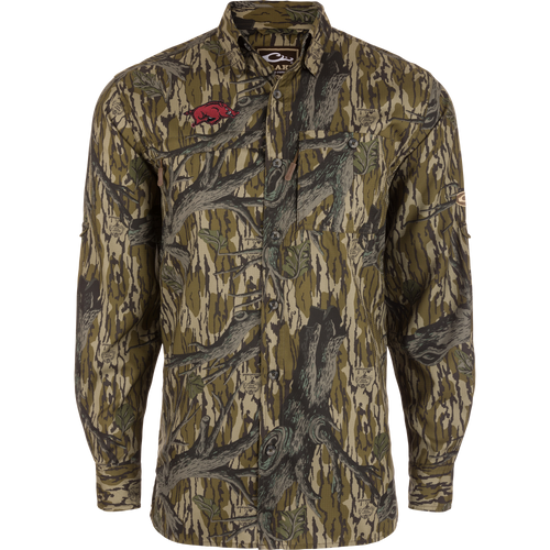 Arkansas 8-Shot Long Sleeve Shirt with bark-and-branch camouflage, red Razorback logo, and right chest zip pocket; features moisture-wicking, UPF30 protection, and vented cape back.