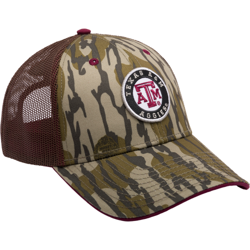 A Texas A&M Bottomland Mesh Back Cap featuring Mossy Oak Camo pattern. Structured with poly twill front, mesh back, X-Peak visor, 3D logo embroidery, and snap-back closure. Ideal for hunting enthusiasts.