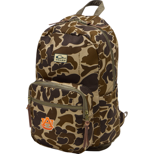 Auburn Throwback 80 Backpack with camo print, brass-tone zippers, leather pulls, and embroidered Auburn University logo; durable cotton canvas and suede bottom.