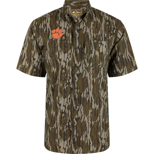 Clemson 8-Shot Short Sleeve Shirt with woodland camo, dual chest pockets, and orange paw-print logo, offering UPF 30 protection with moisture-wicking and quick-drying features.