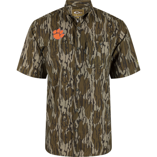 Clemson 8-Shot Short Sleeve Shirt with woodland camo, dual chest pockets, and orange paw-print logo, offering UPF 30 protection with moisture-wicking and quick-drying features.