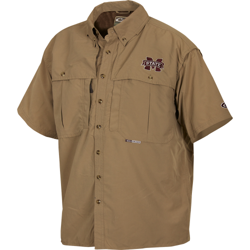 A Mississippi State Wingshooter's Shirt S/S, featuring a logo, short sleeves, and a button design. Breathable and quick-drying with front and back ventilation. Functional with oversized chest pockets and a zippered pocket. Perfect for Game Day.