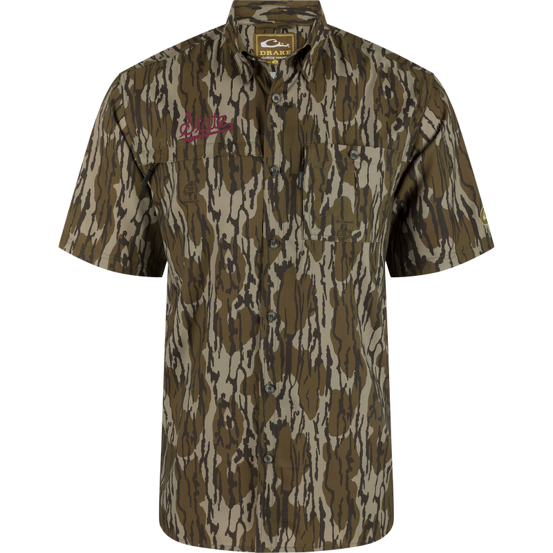 Mississippi State 8-Shot Short Sleeve Shirt features tree-bark camouflage, two chest pockets, and Drake Clothing Company label. Ideal for hunting with moisture-wicking, UPF 30 protection.
