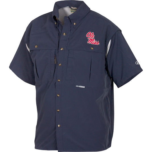 Ole Miss Wingshooter's Shirt Short Sleeve: A blue shirt with a logo, perfect for Game Day. Breathable, cool, and quick-drying. Features front and back ventilation, oversized chest pockets, and a zippered pocket. Made with 100% Polyester twill fabric and Poly-mesh lining in vented areas. From Purewhitelaneshop, high-quality hunting gear and clothing.