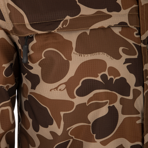 A close-up of the Drake 8-Shot Flyweight S/S Shirt, featuring the exclusive Old School Camo pattern. Lightweight Dobby fabric with built-in stretch, UPF 30 sun protection, and moisture-wicking properties. Classic fit with hidden button-down collar and vented cape back.