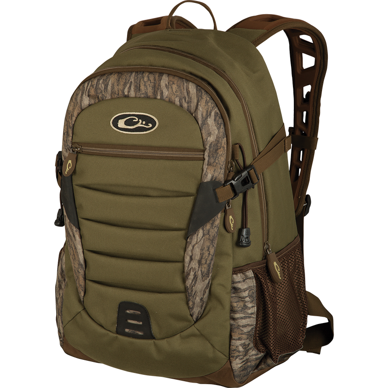 A Drake Daypack, a green backpack with brown straps, perfect for storing essential items in a more compact design. Features large zippered storage area, hydration pouch pocket, EVA shoulder straps, and more. Available in Small and Large sizes.