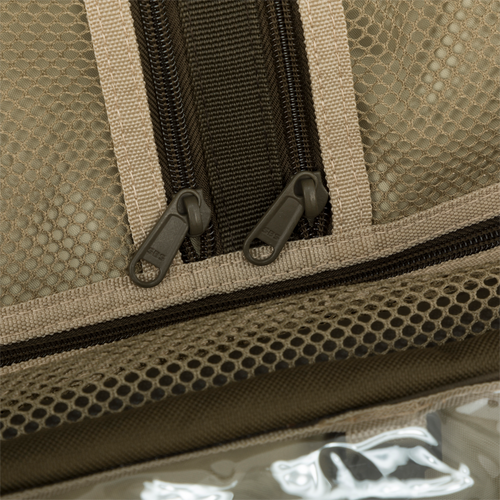 Large Blind Bag with zippers on a bag, close-up of a zipper, and a fabric. Loaded with 18 pockets for organizing gear. Waterproof and durable construction with adjustable shoulder strap. Perfect for hunting and outdoor activities.