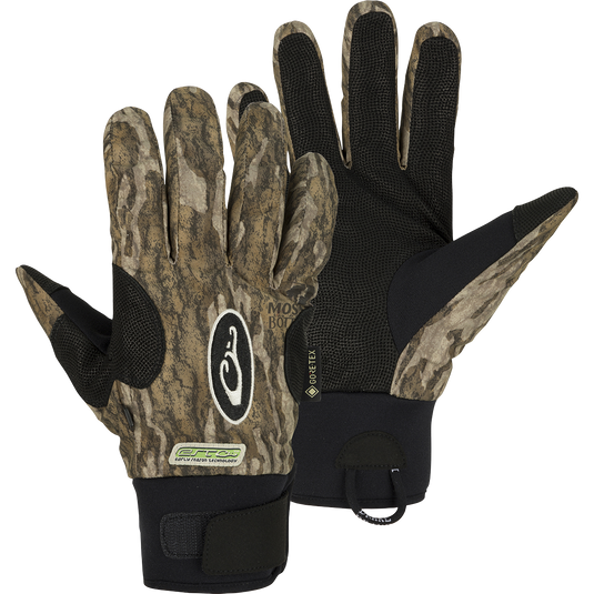 A pair of EST Refuge HS GORE-TEX Gloves with waterproof/breathable protection for waterfowl hunters. Features include a digitized goat skin leather palm and gusseted neoprene cuffs. Stay-Put™ liner system eliminates twisting and bunching. Adjustable gusset Velcro cuff closure and pull loop assist for easy on/off.