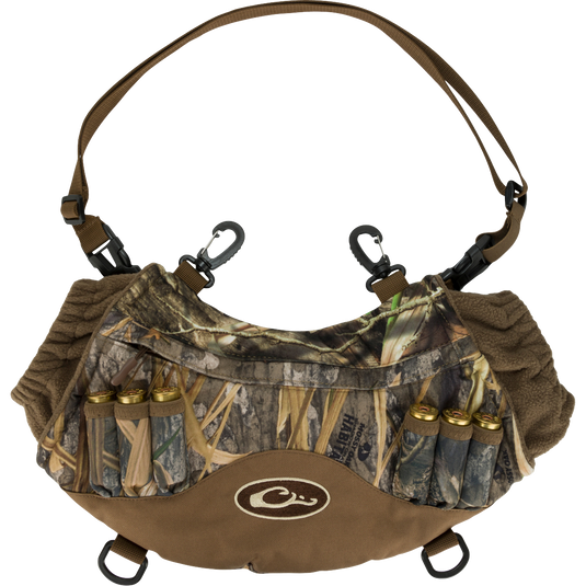 Alt text: LST Handwarmer Muff with camouflage pattern, featuring carabiner clips, shell loops, and a waterproof storage pocket for phone access.